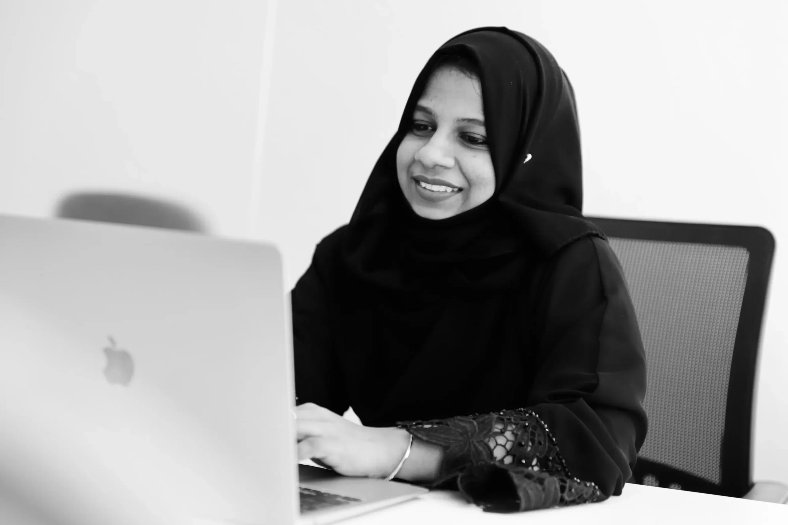 Rizwana Abdul Salam, SEO specialist and consultant in Kerala, is working on a laptop.